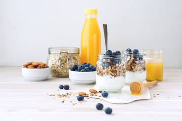 Healthy breakfast in glass jar with yogurt, muesli and blueberries. Healthy food. View from above