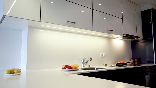 Modern kitchen interior design of the kitchen cabinets and modern kitchen countertop. Counter is made of the natural stone granite or quartz and cabinet doors are made of the natural wood.