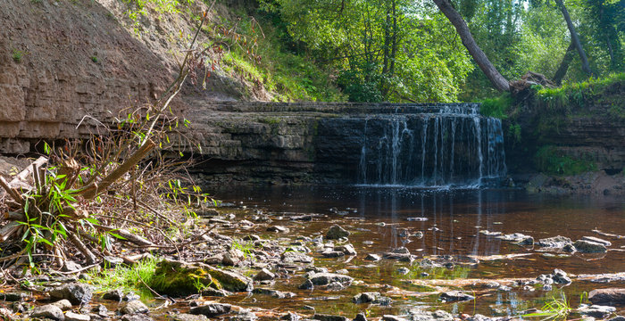 Panorama of waterfall on mountain river on summer day