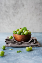 Organic fresh gooseberries in bowl on the table. Close up view