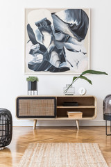 Interior design of living room at nice scandinavian apartment with modern commode, lamp, abstract...