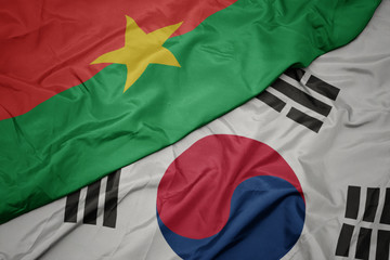 waving colorful flag of south korea and national flag of burkina faso.