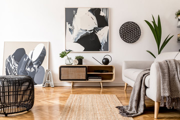Scandinavian and design home interior of living room with wooden commode, gray sofa design black...