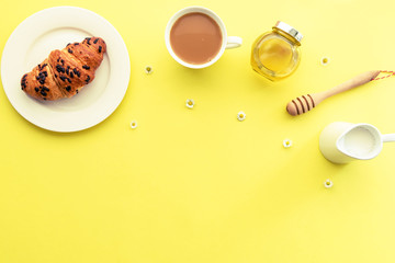Breakfast, morning coffee, croissant, honey and milk, top view, flat lay. Copy space.