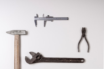 hammer, wrench, pliers, caliper, working tool, top view on white background