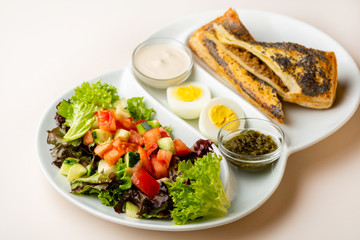 healthy salad with fried eggs and sauce