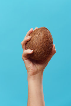 Picture of raised hand with coconut