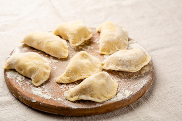 Raw homemade dumpling on wooden board