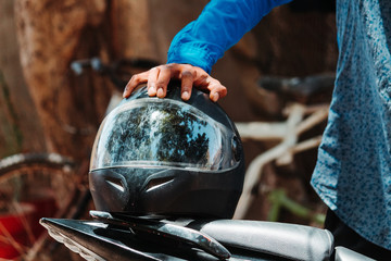 Closeup shot of a man holding helmet in his hand