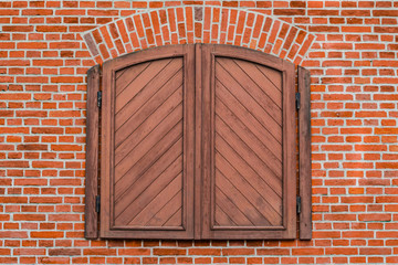 Window closed by old wooden shutters