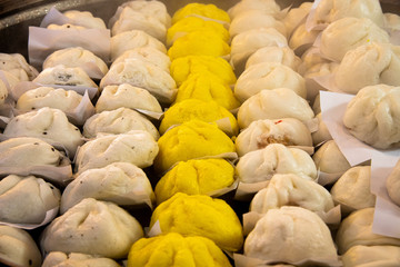 Fototapeta premium Various delicious steamed Chinese buns on steamer.