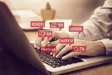 cyber bullying concept. people using notebook computer laptop for social media interactions with notification icons of hate speech and mean comment in social network - obrazy, fototapety, plakaty