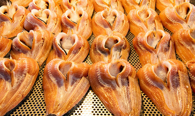 Fototapeta na wymiar Closeup sun gried striped snakeheade fishes with bone arrangement on bamboo tray.