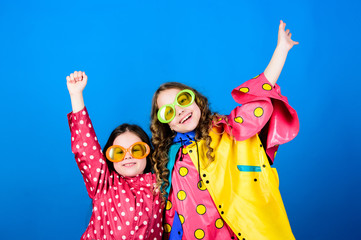 Waterproof accessories make rainy day cheerful and pleasant. Waterproof fashion. Waterproof accessories for children. Sisters happy wear waterproof cloak. Enjoy rainy weather with proper garments