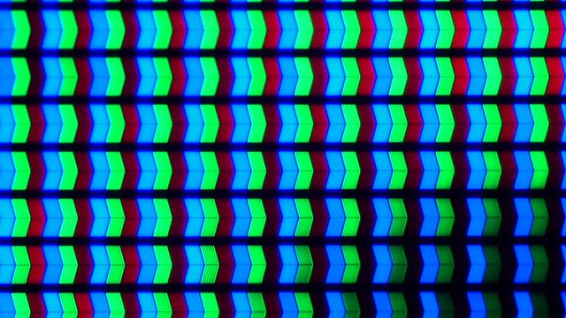 Macro view of the pixels of a TV or computer screen. Multi-colored pixels.