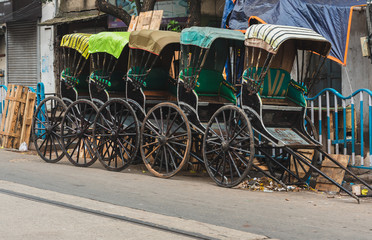 Fototapeta na wymiar Hand-pulled Rickshaw parked at the Roadside. 