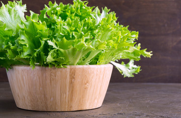 Fototapeta premium Fresh crispy salad in a wooden bowl
