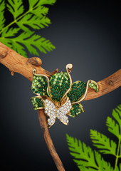 Jewelry ring with gems on branch with leafs