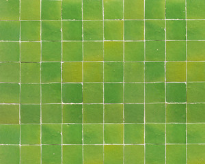 Old retro green ceramic tile texture background. Green square tiled wall.