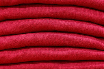 Stack of trend Biking Red sweaters close-up, texture, background