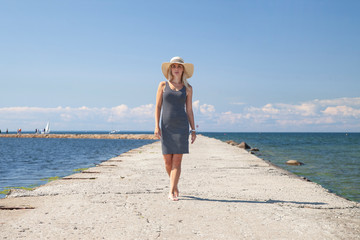 happy woman on the beach at sea at sunset.