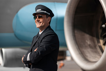 Smiling handsome pilot in uniform having rest after work © Yakobchuk Olena