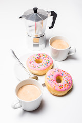 Fresh hot coffe and pink sweet donut on white background isolated