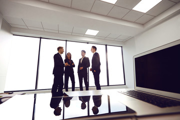 A group of businessmen at a meeting in a business office