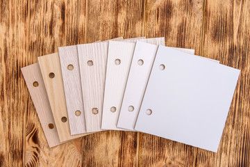 Plywood sampler on wooden background close up