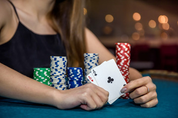 Woman in casino showing combination of aces