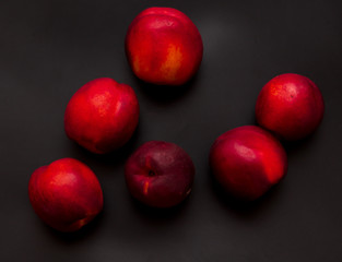 Ripe nectarine on a black background