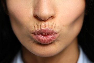 Attractive mature woman making kissing gesture
