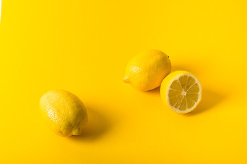 Natural fresh juicy lemons on yellow background
