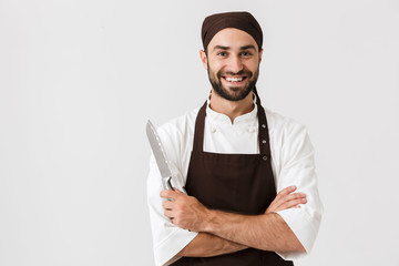 Cheerful smiling optimistic young su chef posing isolated over white wall background in uniform...