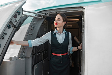 Attractive female flight attendant is on duty on board