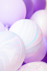 Vertical close up banner of purple and violet balloons as a background. Birthday background with ballons.