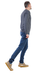 Fototapeta premium Side view of going handsome man. walking young guy .