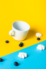 Abstract arrangement with food and different objects on yellow and blue
