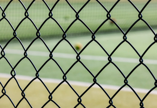 chain link  looking on to tennis court