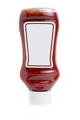 A blank label tomato ketchup glass bottle upside down on white background