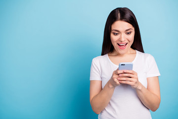 Copyspace photo of nice cute cheerful girl seeing information about sales on her phone while isolated with blue background