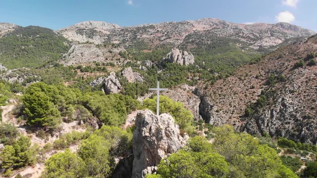 A cross on the top of a rock in Abdet village, in Alicante mountains, Spain