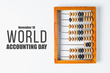 Old wooden abacus and text "World accounting day"  on white background. The concept of bookkeeping, business or saving money