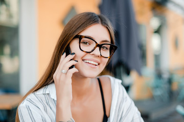 beautiful woman in glasses talks on the phone