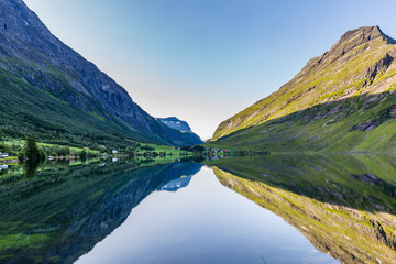 Moutains reflecting in the water of lake Eidsvatnet in Eidsdal along national scenic road 63, Trondelag county in Norway