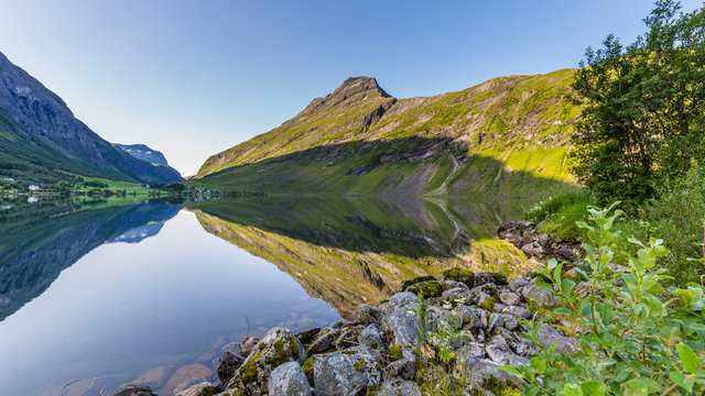 Moutains reflecting in the water of lake Eidsvatnet in Eidsdal along national scenic road 63, Trondelag county in Norway