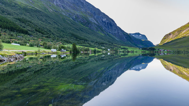Moutains reflecting in the water of lake Eidsvatnet in Eidsdal along national scenic road 63, Trondelag county in Norway