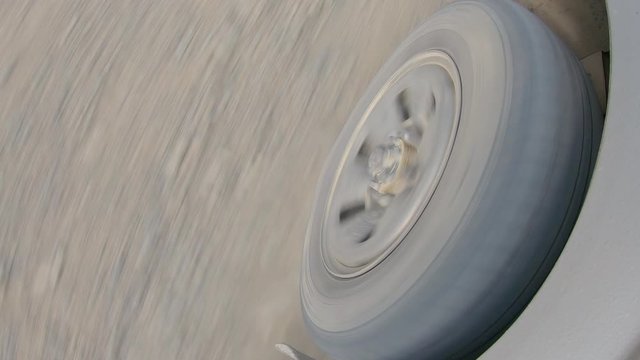 the minibus is driving off-road. spinning wheel closeup at speed along a gravel road. summer. video footage stock. 4K
