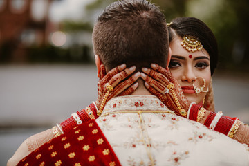 A beautiful bride Hindu hugs her husband on the wedding day