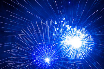 Blue firework in the night sky. Blue background